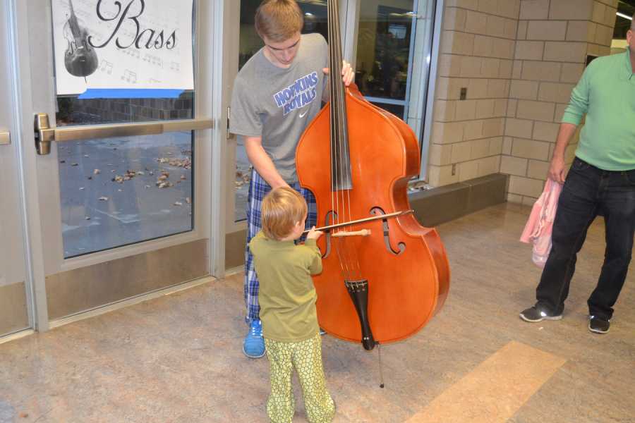 Ryan Dahnke, senior, lets a kid try his bass. 