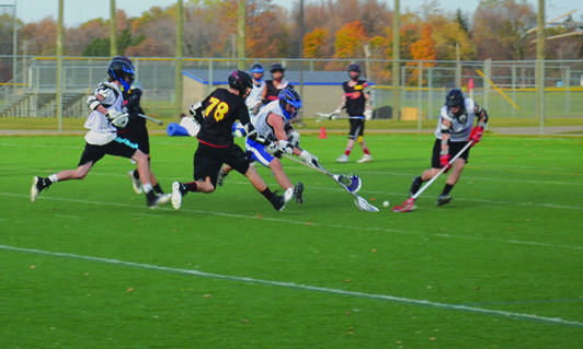 Elliot Carson, senior, and Jimmy Tomlinson, junior, fight for the ball in their game vs Manitoba, Canada.