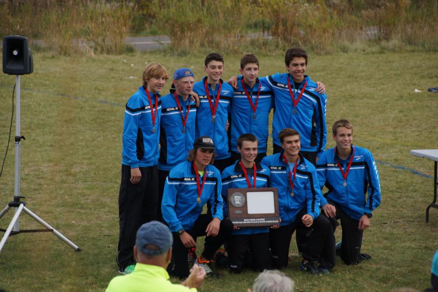The boys varsity team displays their trophy. They finished as the second team overall, qualifying for state.
