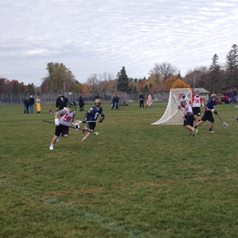 A Lakeville North player carries the ball behind his own net. Lakeville North participated in the HS Varsity division.