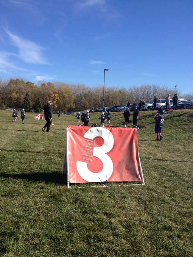 Young players warm up in front of a field marker. Games were held on six fields at HHS and three fields at WJH.