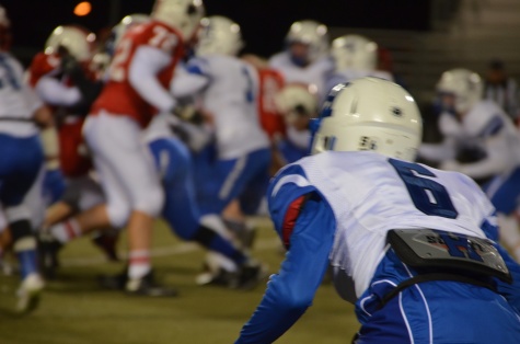 Malik Lofton, sophomore, watches his teammates block and tackle during a defensive play. 
