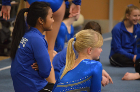 Liana Rojas, sophomore, and Riley ONeil, 8th grade, wait for the meet results with their teammates. 