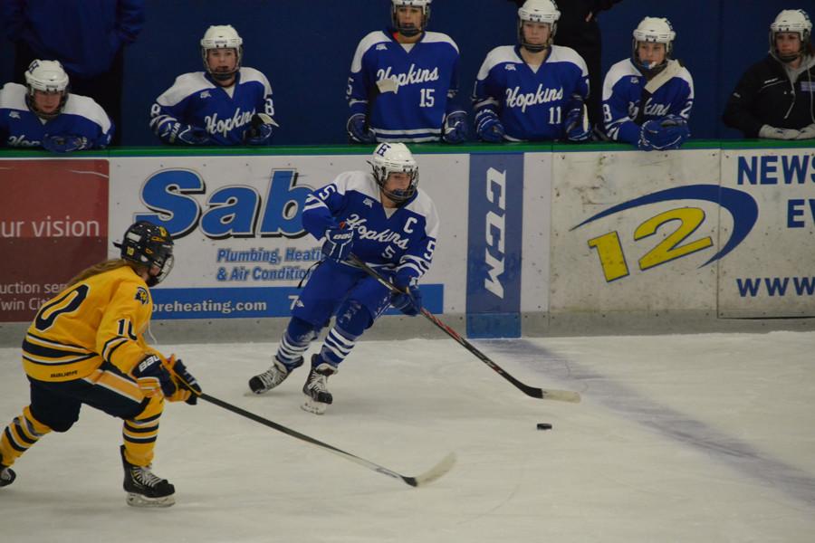 Corbin Boyd, senior, before she passes the puck. The Royals lost 3 to 1 against Wayzata. 