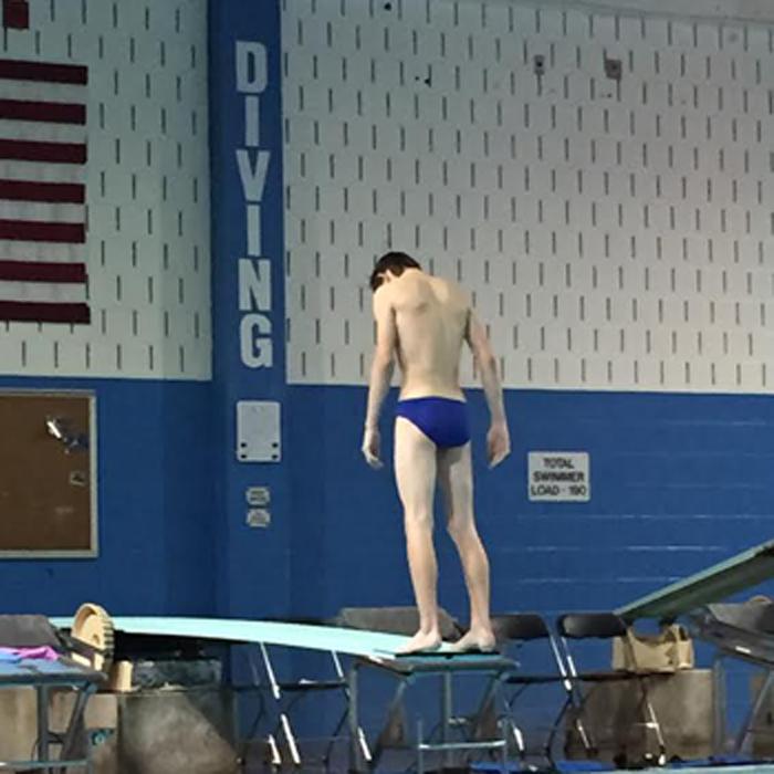 Phillip Bradshaw, senior, stands on the diving board before his first dive.