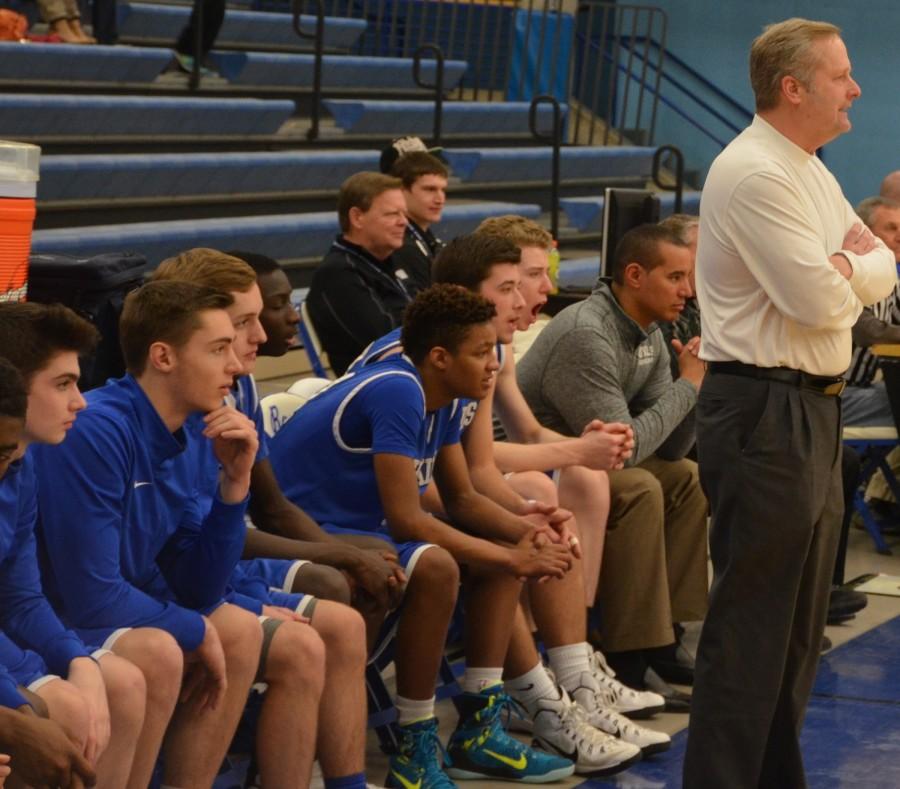 Coach Novak and the Hopkins bench observe the game.