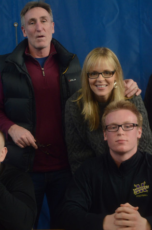 Kyle Johnson, senior, poses with his family after signing.