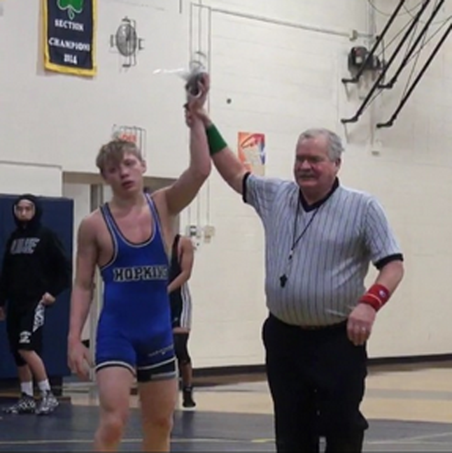 Willie Rohweder, junior, is declared winner of a match by the referee.