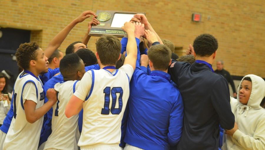 Boys basketball team celebrates with the Section 6AAAA trophy after the 59-58 win over Eden Prairie.