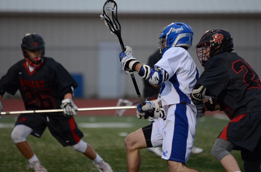 HHS boys lacrosse team plays in the offensive zone against Eden Prairie.