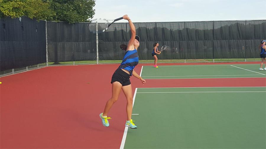 Yelena Hallman, sophomore, serves during the match against the Jaguars.