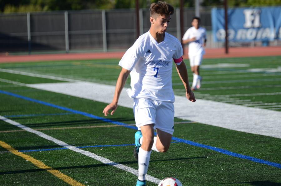 Nico Soffer, senior, dribbles the ball down the field in the game against the Wayzata Trojans.