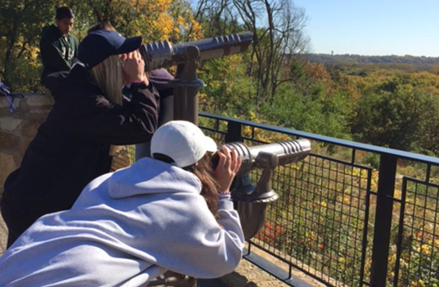 Maddie Holicky and Abby Feitl, sophomores, look through telescopes at the view of the refuge.