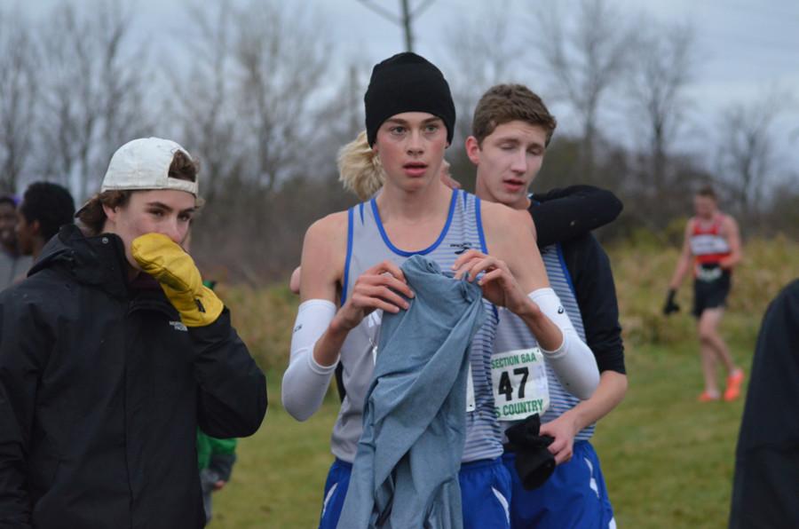 Owen Hoeft, senior, puts clothes back on after the snowy 6AA section race.