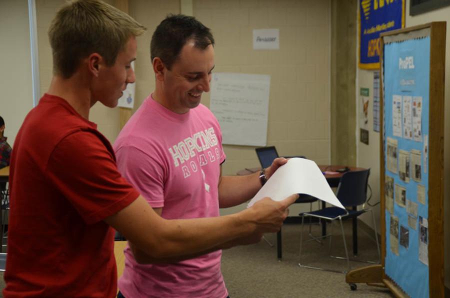 Isaac Johnson, senior, and Mr. Jesse Theirl, business education, work together during ProPEL class.