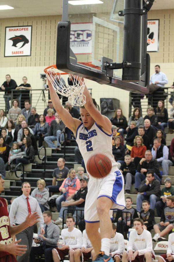 Simon Wright, junior, dunks during his 24-point performance against the Cougars. The Royals moved to 2-0 after this win.