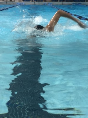Isaac Gotlieb, freshman, races in the 100 yard freestyle.