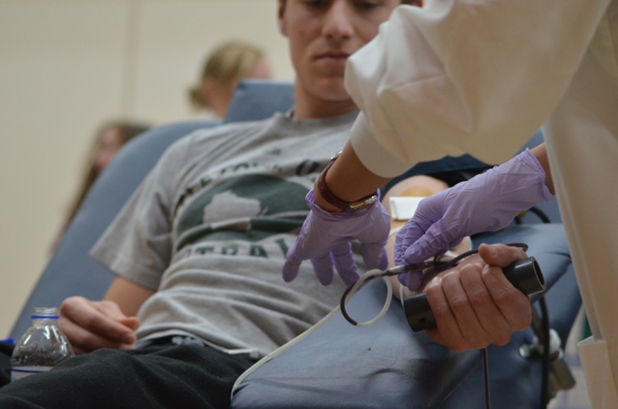 Issac Johnson, senior, gives blood at the Memorial Blood Drive on Wednesday, Feb. 24, 2016.