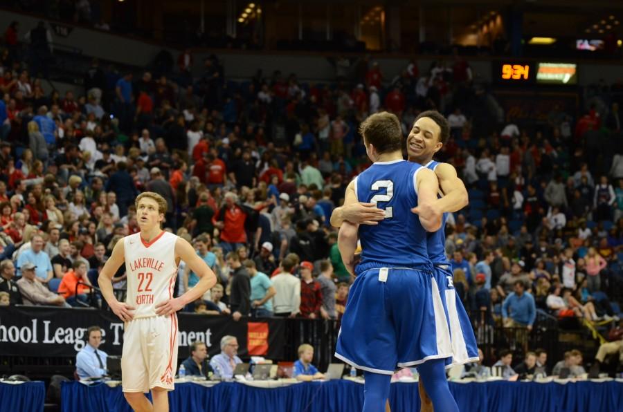 Amir Coffey, senior, and Simon Wright, junior, embrace during the AAAA state final game.