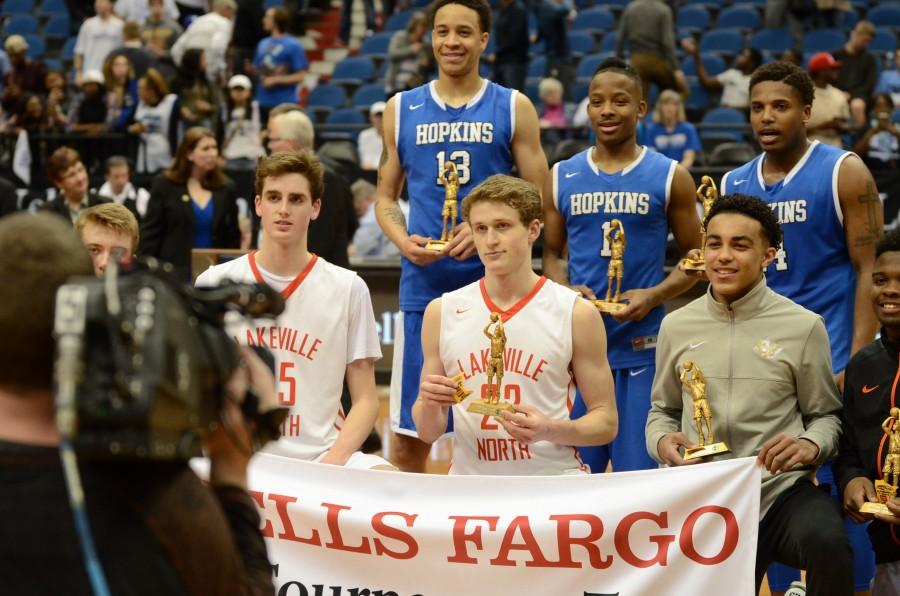 Amir Coffey, Vinnie Shahid, and Xavier Johnson, seniors, receive their trophies for the All Tournament Team at the AAAA state final game.