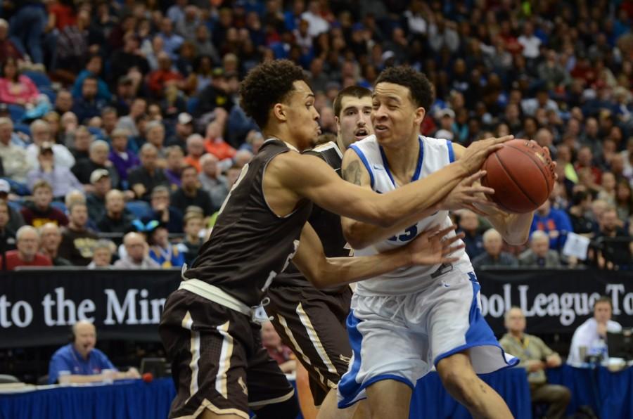 Amir Coffey, senior, protects the ball from Gary Trent, Jr.  in the semifinal state game.