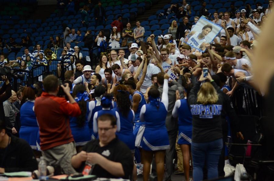 The HHS boys basketball team brings the championship trophy to the fans in the stands after the AAAA state final game.