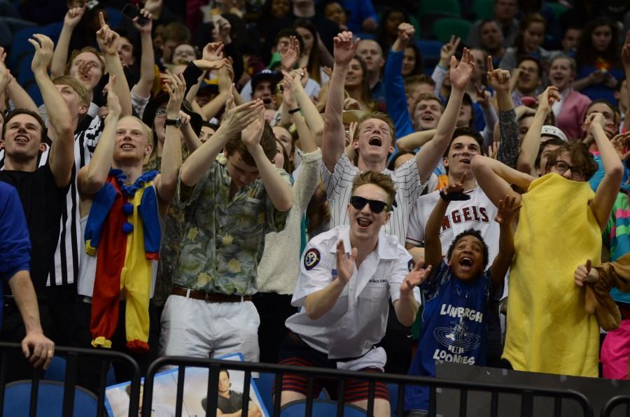 The HHS fan section cheers for the boys basketball team at the semifinal state game against Apple Valley.