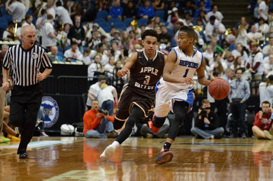 Xavier Johnson, senior, dribbles the down down the court in the semifinal state game against Apple Valley.