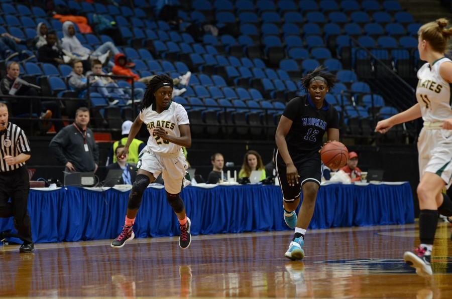 Nia Hollie, senior, dribbles the ball down the court in the quarterfinal state game.