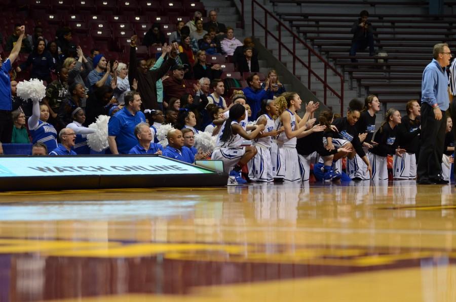 The HHS girls basketball team cheers for their teammates after a shot in the semifinal state game.