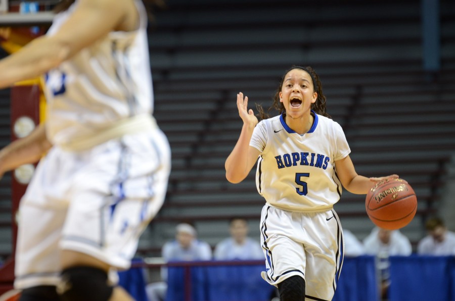 Dee Dee Winston, junior, yells to her teammates while dribbling the ball down the court in the semifinal state game.