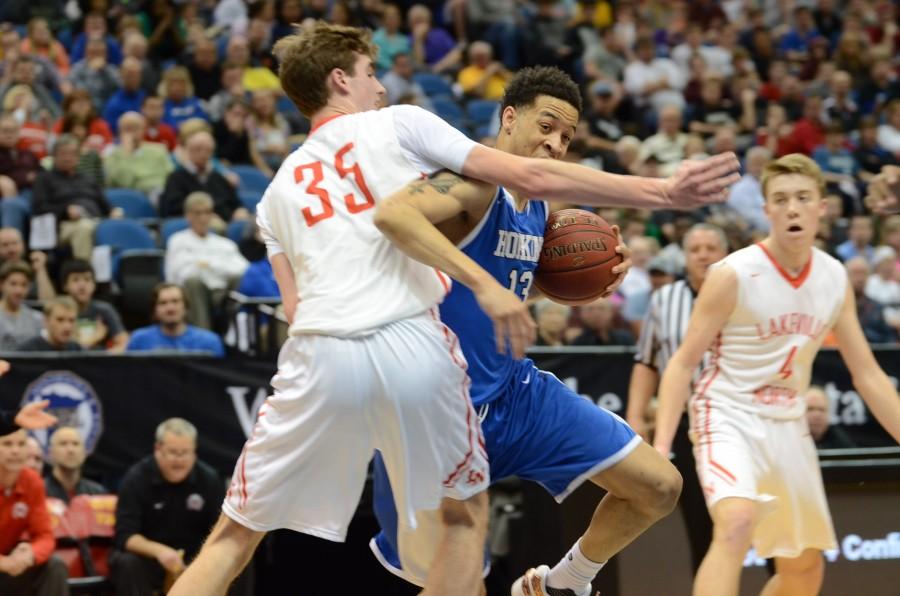 Amir Coffey, senior, pushes away a defender in the offensive end in the AAAA state final game.
