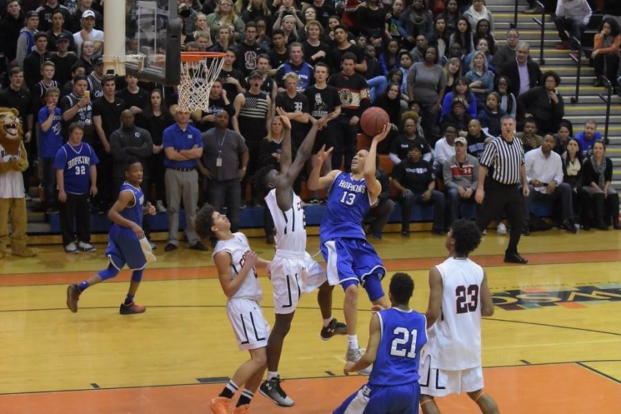 Amir Coffey, senior, shoots the ball in the section championship. Coffey finished with a game-high 26 points.