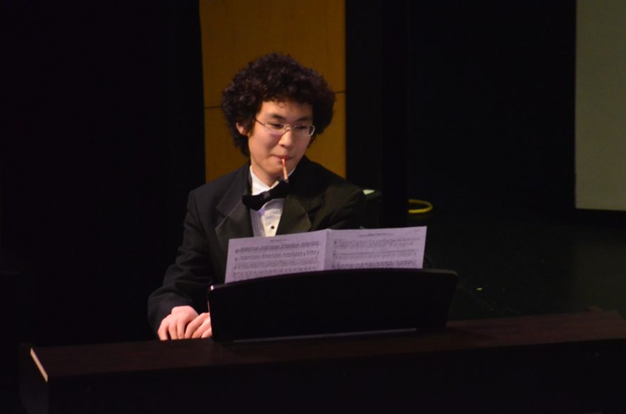 Maxim Peng, junior, accompanies the band on the piano.