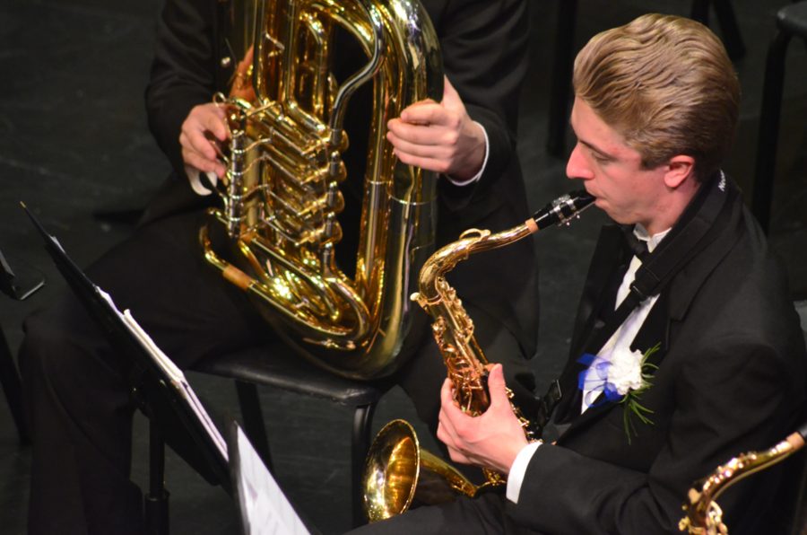 Jens Melby, senior, plays the saxophone in the spring band concert.