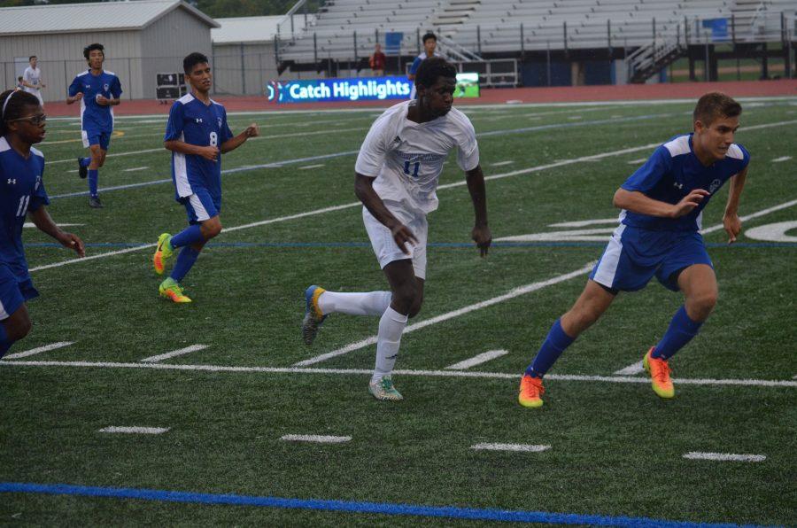 Clarence Wea, freshman, dribbling ball downfield against the Skippers. 