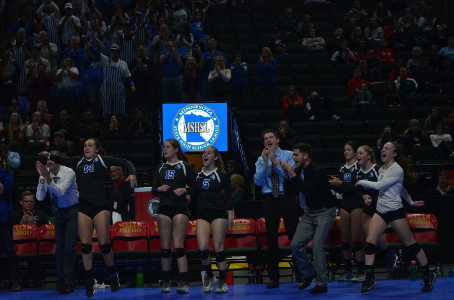 The bench celebrates after Hopkins scores the winning point of the first state game against Moorhead.