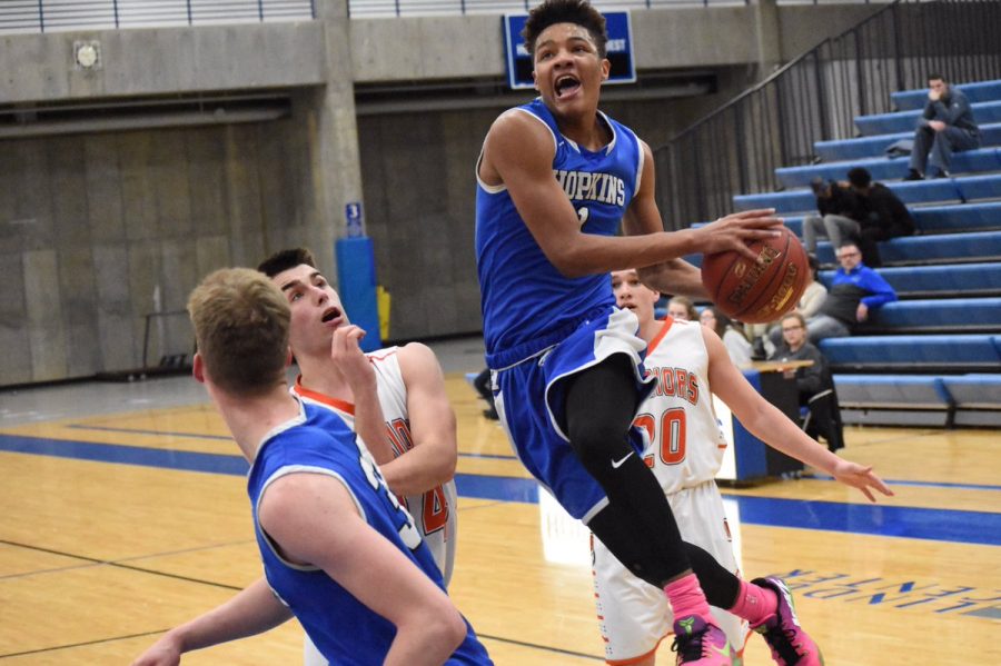 Ishmael El-Amin, HHS alum, goes up for lay up against Washburn. El-Amin currently plays basketball for Ball State University. 