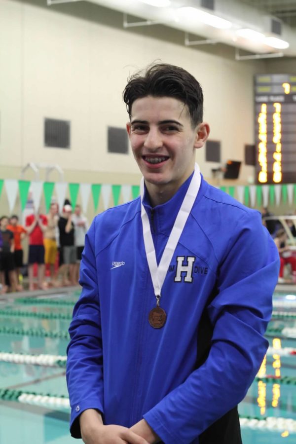 Elliot Berman, NJH eighth grader, medals in the 100 yard butterfly at the section 6AA final meet. Berman placed third in the event, swimming a time of 55.45 seconds.