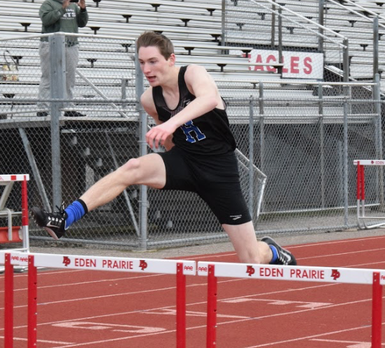 Joe Swenson,senior, runs the hurdles at meet last year. 