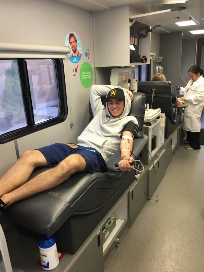 Ross+Nordean%2C+junior+poses+after+getting+his+blood+drawn.+The+Blood+drive+was+on+April+20.+