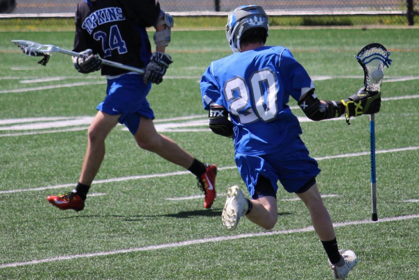 Cole Kristal, sophomore, cradles lacrosse ball down field. 