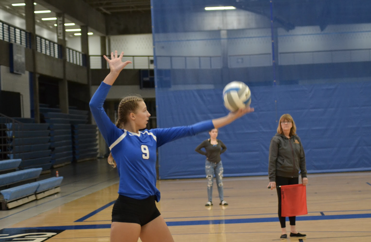 Ana Erickson, junior, prepares to serve. The Royals fell the the Minnetonka Skippers in four sets yesterday, September 19th. 