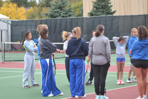 Girls tennis huddles up to discuss practice plans.