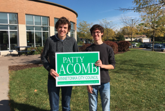 Left to right: Charlie and Jack Acomb. Posed outside of HHS with Patty Acomb sign. 