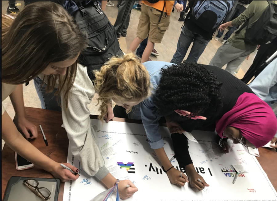 Students sign a banner during lunch as a symbol of their alliance with the LGBT community. Banner signing was one major aspect of GSAs Ally Week celebrations.
