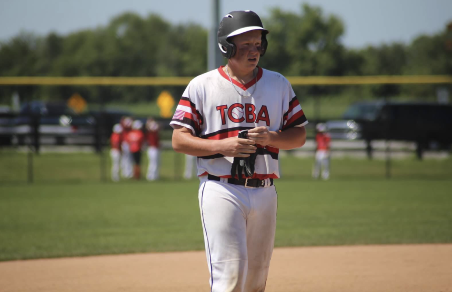 Tommy Auth, senior, comes off the field after base hit. Auth played for the TCBA (Twin Cities Baseball Academy) this summer. 
