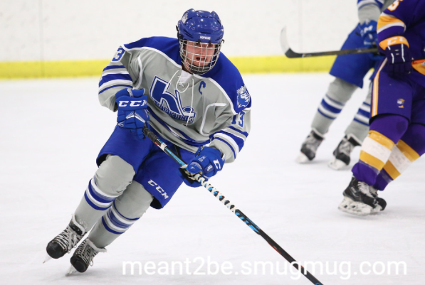 Johnny Kahner, senior, captain, skates ups ice and looks for pass from teammate. 