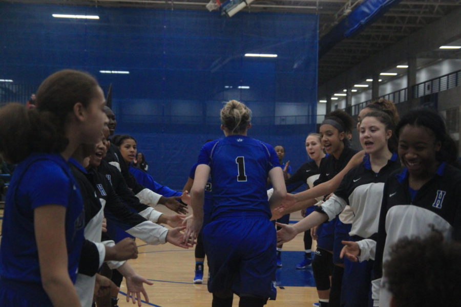 Paige Bueckers, sophomore, runs through the tunnel of teammates as she enters the court at Lindbergh Center.
