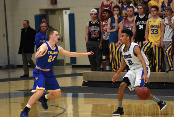 Anthony Davis, senior, dribbles in front of Wayzata defender last year. The Royals look to beat the Trojans after losing to them last year in the section finals. 